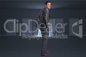 Composite image of smiling businessman with hands on hips