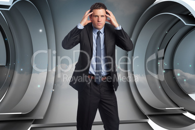 Composite image of stressed businessman with hands on head