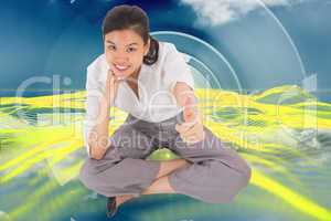 Composite image of businesswoman sitting cross legged showing th