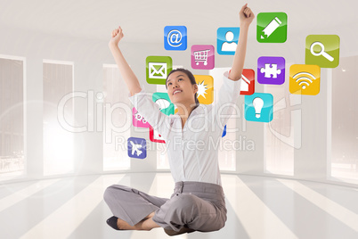 Composite image of businesswoman sitting cross legged cheering