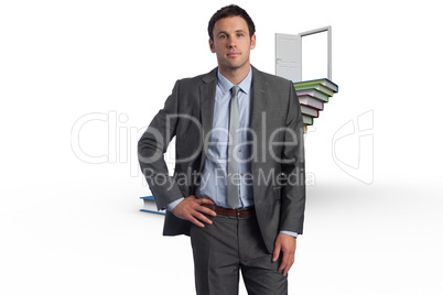 Composite image of serious businessman with hand on hip