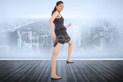 Composite image of businesswoman stepping up