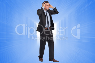 Composite image of stressed businessman with hands on head