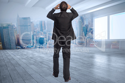 Composite image of stressed businessman with hands on head