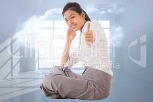 Composite image of businesswoman sitting cross legged showing th