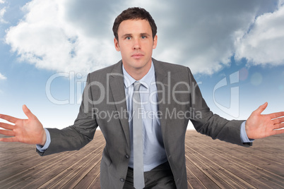 Composite image of businessman posing with hands out Composite image of businessman posing with hands out