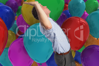 Composite image of businessman standing with hands up