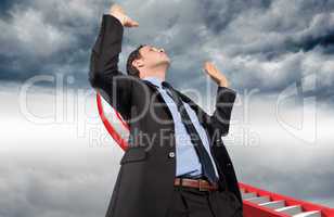 Composite image of businessman posing with arms raised