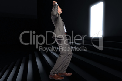 Composite image of businessman posing with hands up