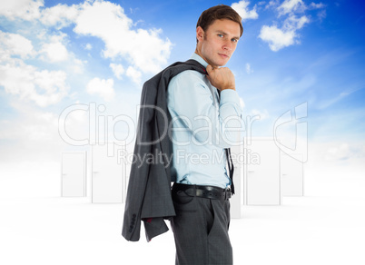 Composite image of serious businessman holding his jacket