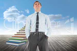 Composite image of happy businessman standing with hands in pock