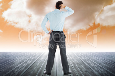 Composite image of thoughtful businessman with hand on head