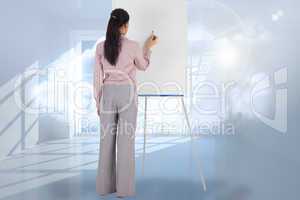 Composite image of businesswoman painting on an easel