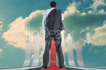 Composite image of businessman holding his jacket