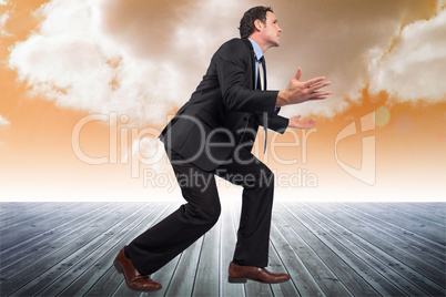 Composite image of businessman posing with arms outstretched
