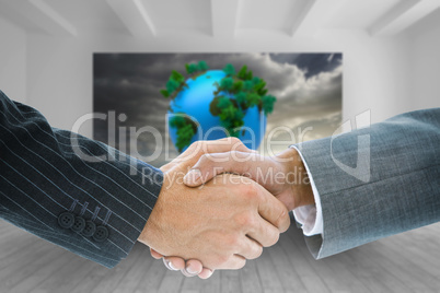 Composite image of business handshake