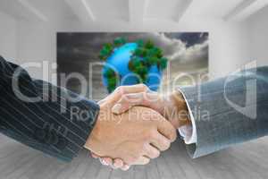 Composite image of business handshake