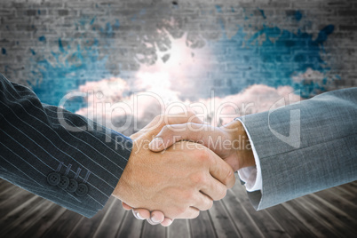 Composite image of business handshake