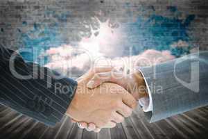 Composite image of business handshake