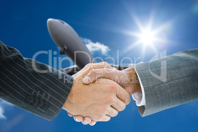 Composite image of business handshake
