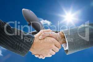 Composite image of business handshake