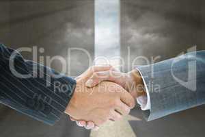 Composite image of business handshake