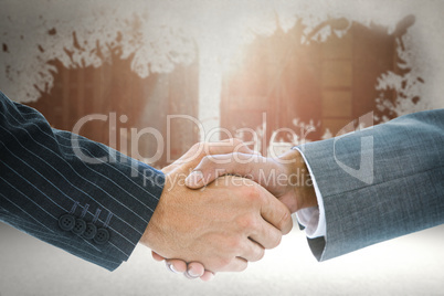 Composite image of business handshake