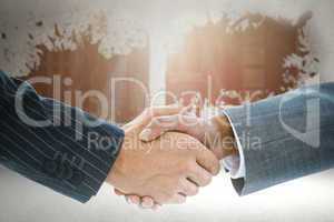 Composite image of business handshake