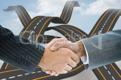 Composite image of business handshake