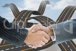 Composite image of business handshake