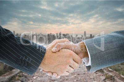 Composite image of business handshake Composite image of business handshake