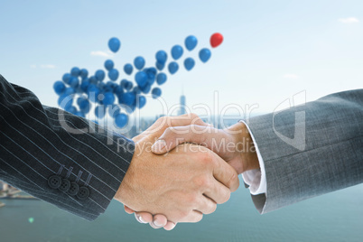 Composite image of business handshake