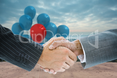 Composite image of business handshake