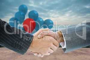 Composite image of business handshake