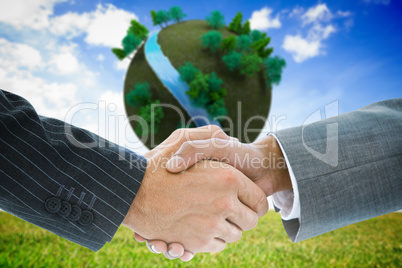 Composite image of business handshake