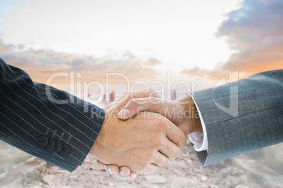 Composite image of business handshake