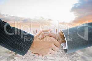 Composite image of business handshake