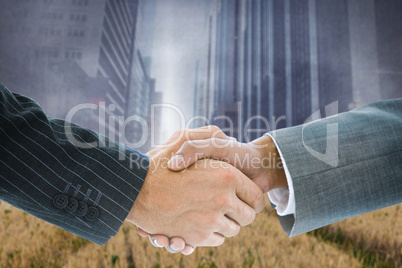 Composite image of business handshake