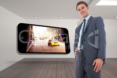 Composite image of cheerful businessman with hand on hip