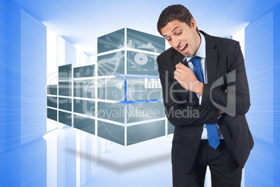 Composite image of thinking businessman holding pen