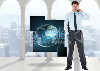 Composite image of serious businessman holding his jacket