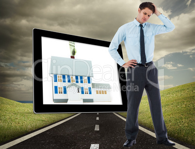 Composite image of thoughtful businessman with hand on head