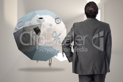 Composite image of businessman with hand on hip