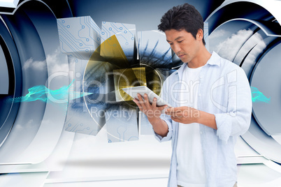 Composite image of male looking at his tablet computer