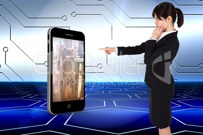 Composite image of businesswoman pointing