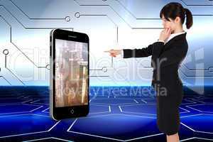 Composite image of businesswoman pointing