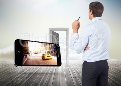 Composite image of thinking businessman holding pen