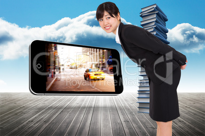 Composite image of smiling businesswoman bending