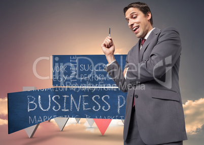 Composite image of thoughtful businessman holding pen