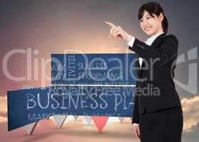 Composite image of smiling businesswoman pointing